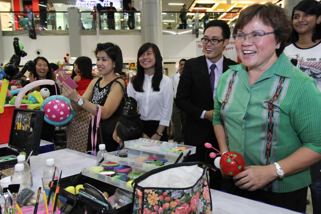 FACE PAINTING: Ms Ellen Lee (second from right) sharing a lighthearted moment with TOTs president Ashley Tay (third from right).