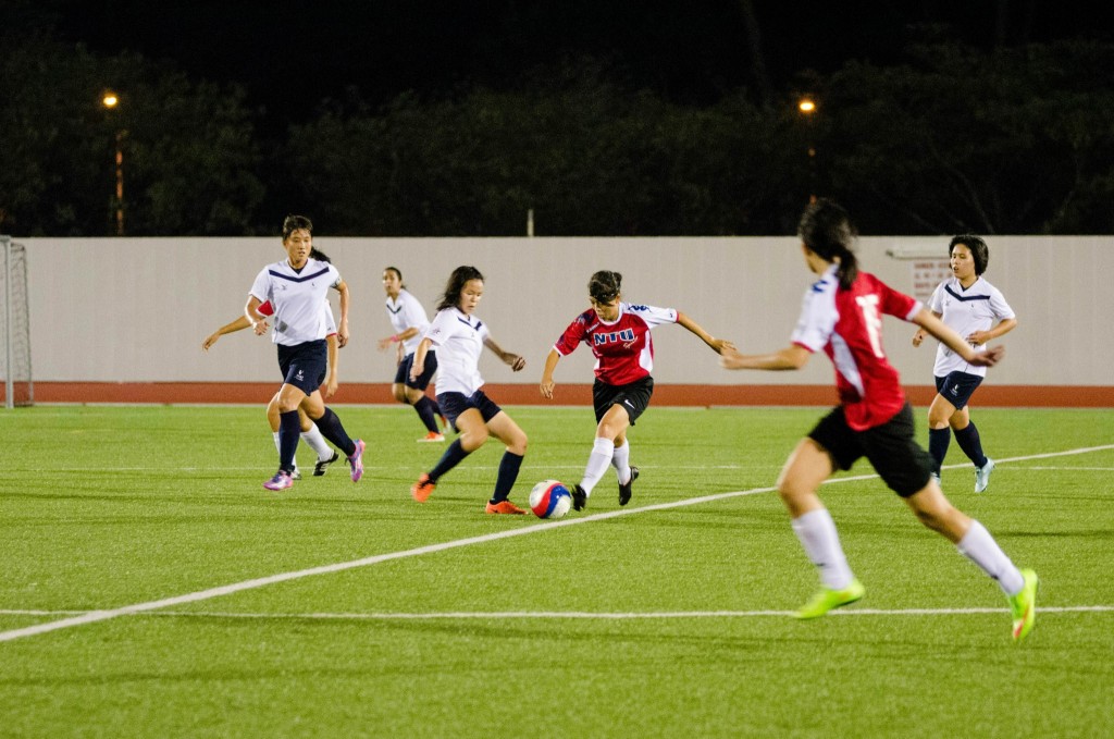BEATING OPPONENTS: An NTU player dribbles past an SMU player towards goal.  PHOTO BY: NTU Spirit