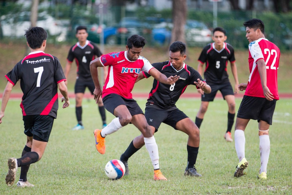 NTU's Pradeep Ravichandran dribbles the ball to avoid a tackle from a Temasek Polytechnic player.  PHOTO: Nicholas Yeo