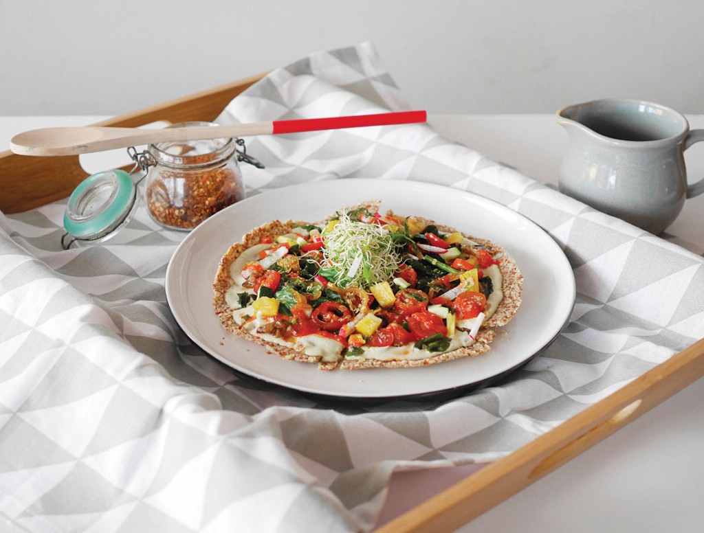 Afterglow’s Raw Basil Alfredo Pizza is made with a pesto cashew spread, marinated cherry tomatoes and wakame seaweed.  PHOTO: AFTERGLOW