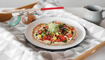 Afterglow’s Raw Basil Alfredo Pizza is made with a pesto cashew spread, marinated cherry tomatoes and wakame seaweed. PHOTO: AFTERGLOW
