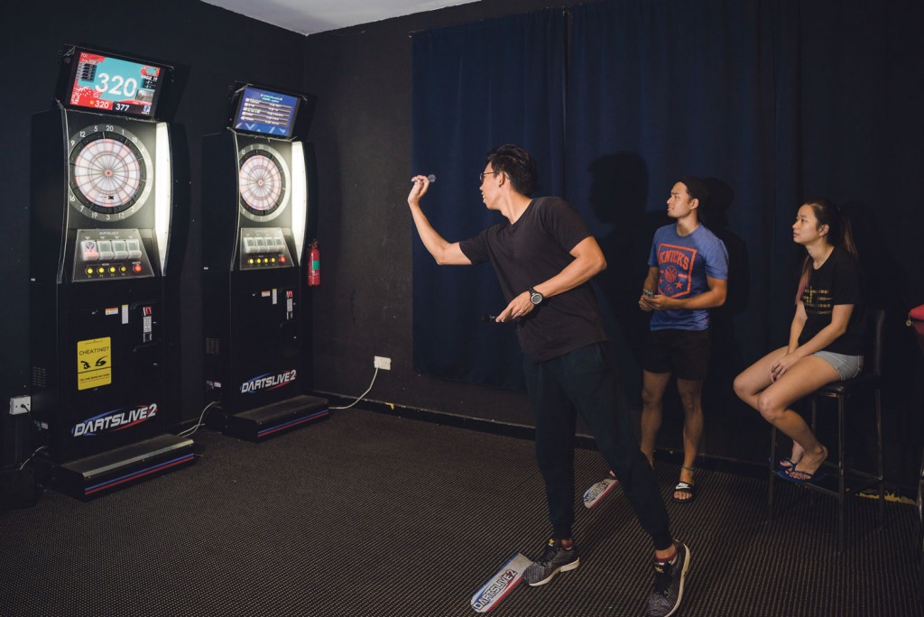 After their meals at Canteen 2, NTU students Jabrian Toh, Lin Shiyi and Hong Yun Ting (from left to right) play darts at the Black and White Room. PHOTOS: ZHENG JUNCEN