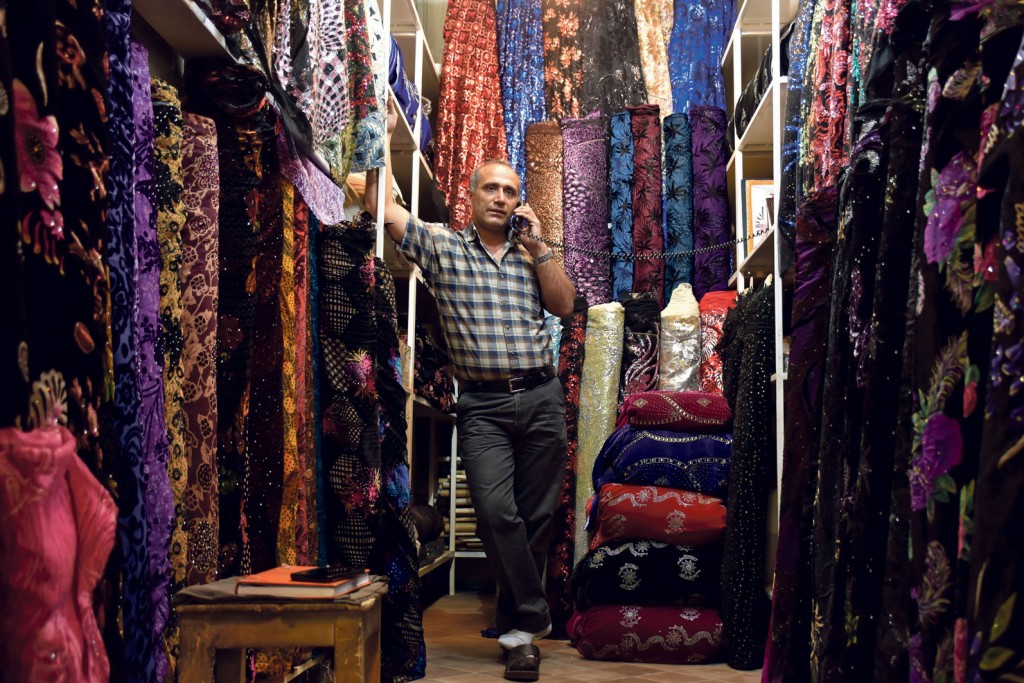 FLAWLESS FABRICS: A shopkeeper selling woven textiles poses for a photo at Shiraz’s Vakil Bazaar.