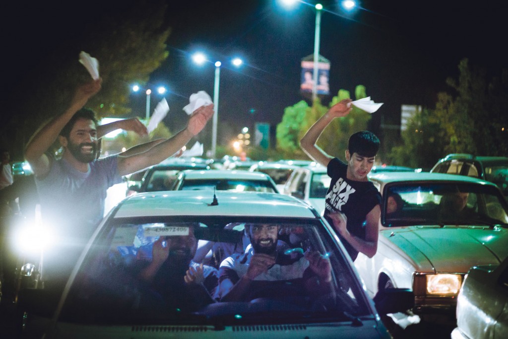 FOOTBALL FRENZY: Fans of Qashqai FC hang out of car windows waving tissue paper as they celebrate a shock win over Persepolis FC out on Shiraz’s Chamran Boulevard.