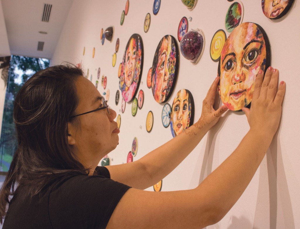 Madam Lai removes her artwork on the final day of the V: A BA Grad Show exhibition. Her piece, titled In Your Eyes, depicts Amberly’s first experience with bubbles.