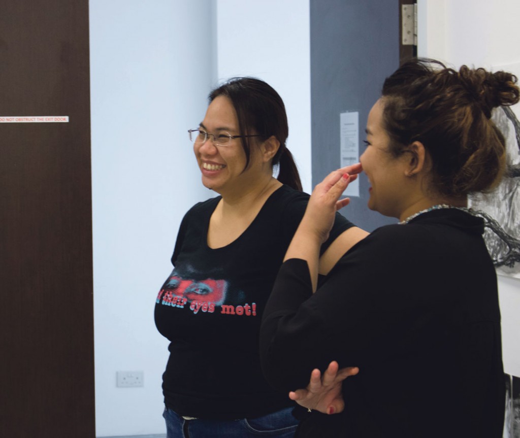 Madam Lai (left) talks to her FYP groupmate from the Studio Specialization module at NIE. 