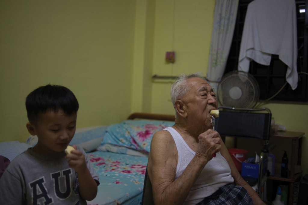 Gong gong eats an apple with my cousin and his grandson — four-year-old Ivan Choo. While gong gong uses dentures, Ivan’s adult teeth are only just beginning to grow out, making their eating speeds much the same despite the drastic difference in age.