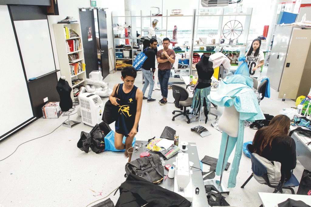 Iskandar Ruhaizat does a final check around the classroom while others make finishing touches before leaving for the venue.