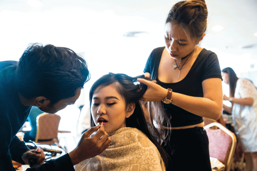 Ruohan, an exchange student from the United States, gets her look done by student makeup artists Vimal Kumar and Audrey Ng.